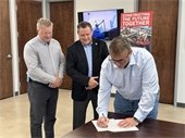 Ozinga's VP & General Manager Herb Moeckel signing agreement