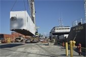 Heavy Lift Services loading shipping container home onto cargo ship