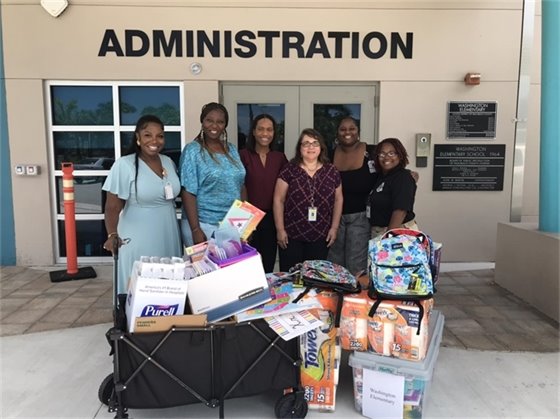 Heavy Lift Services VP Tina Dias with Washington Elementary School Principal and staff