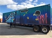 Shipping container home with fish painted on it