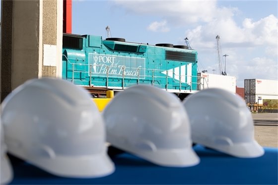 Hard hats and locomotive in the background