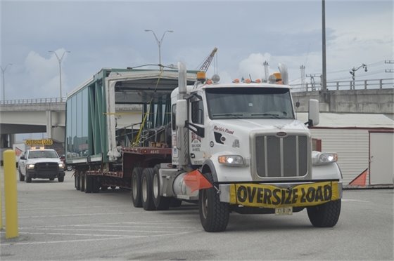 Truck and trailer hauling passenger loading bridge 