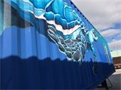 Shipping container home with turtle painted on it