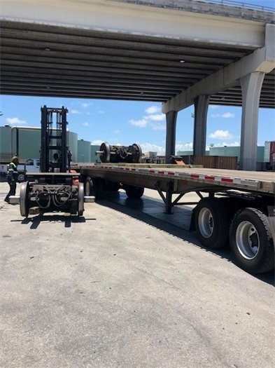 Old rail wheels loaded onto chasis