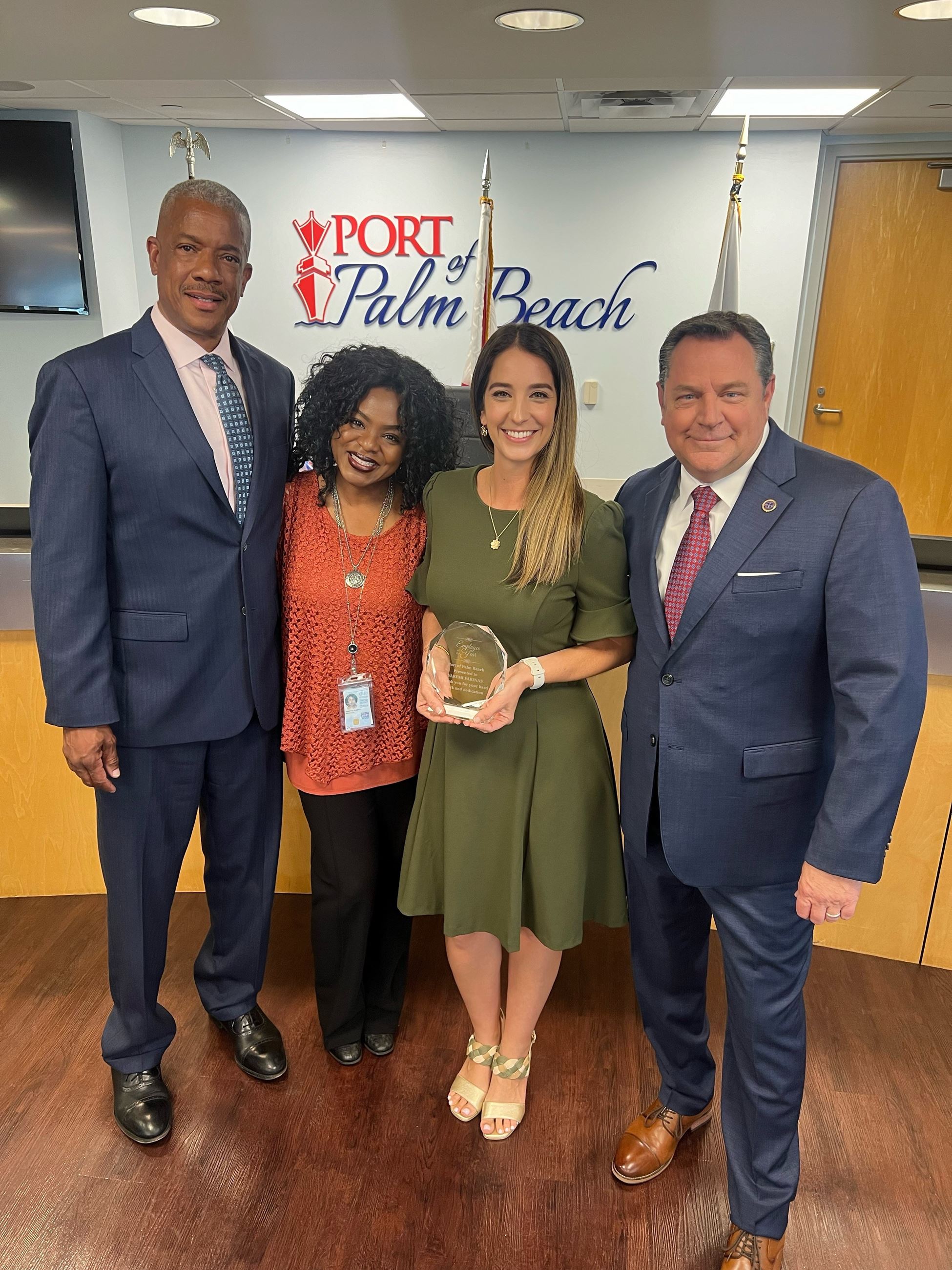 Yaremi Farinas Employee of ther Year, with Board Chairman Wayne Richards, Executive Director Michael